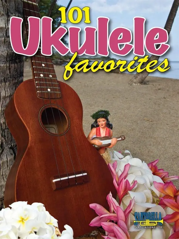 A ukulele is sitting on the ground near flowers.